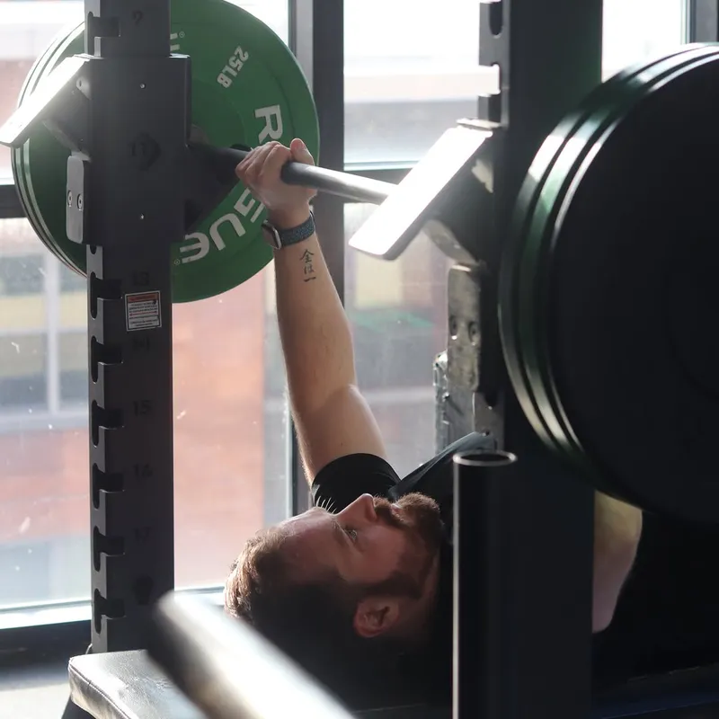Member training with a barbell at XCEL Athletic Lifestyle, a rooftop gym in Hoboken, NJ