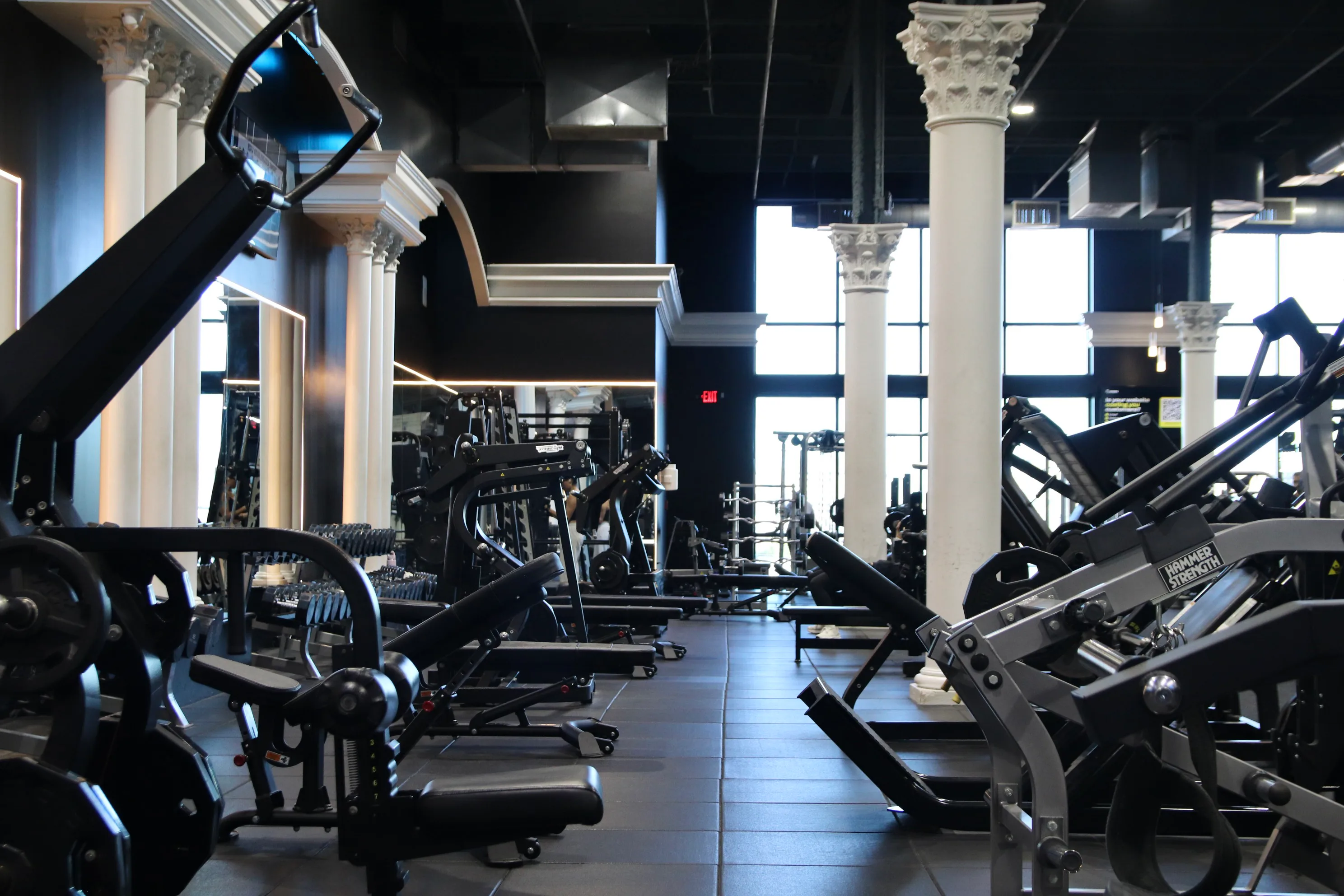 Strength training floor with columns and heavy machines at XCEL Athletic Lifestyle, a rooftop gym in Hoboken, NJ