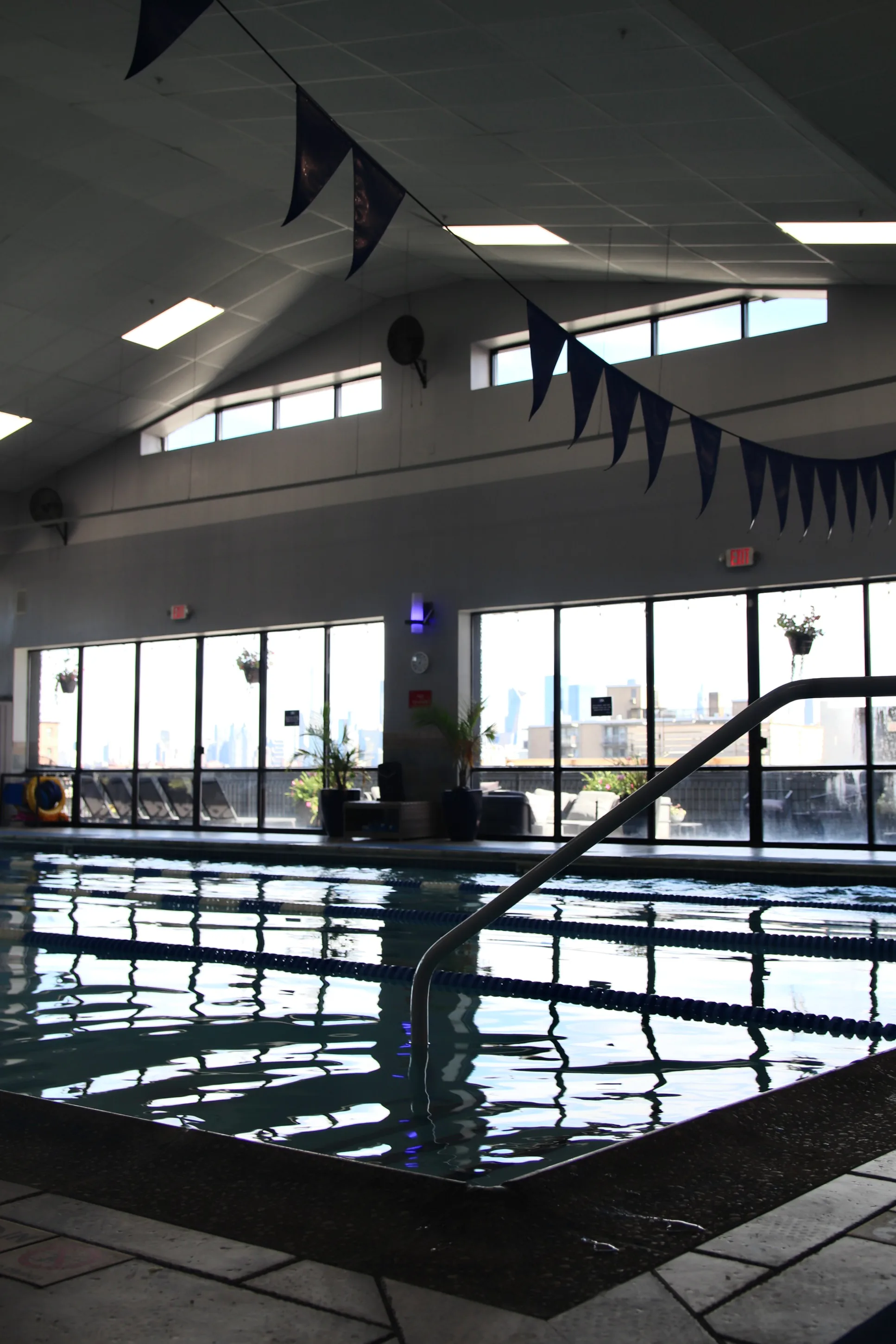 Heated indoor pool deck and lap lanes at XCEL Athletic Lifestyle, a rooftop gym in Hoboken, NJ