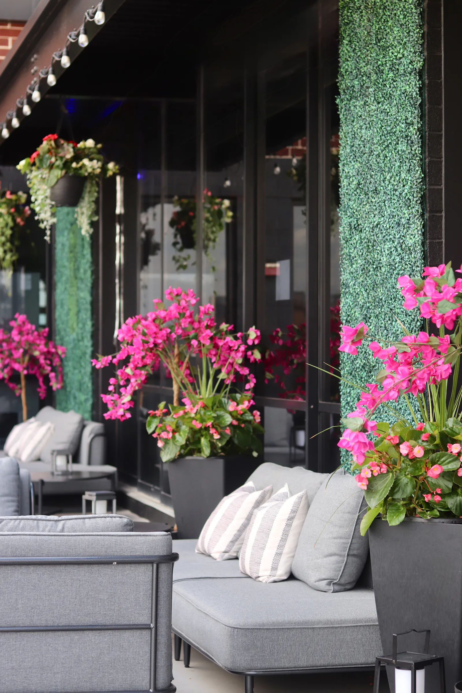 Rooftop terrace lounge with flowers and seating at XCEL Athletic Lifestyle, a rooftop gym in Hoboken, NJ